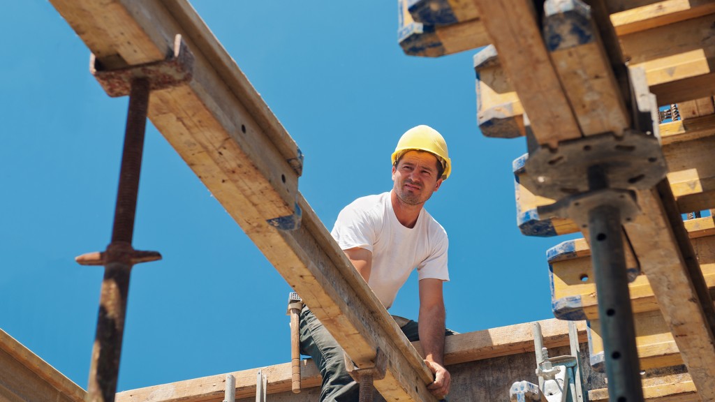 Construction worker placing formwork beams